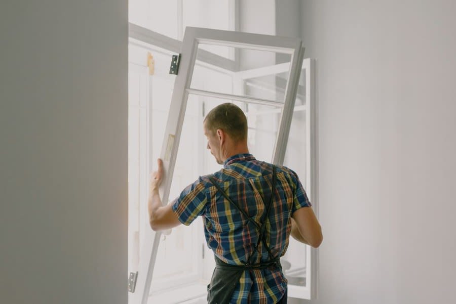Installer fitting a door frame during bi-fold door installation