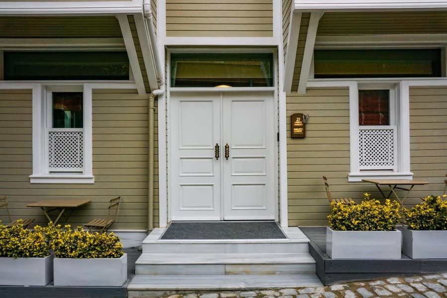 White framed patio and bi-fold style doors on residential property exterior