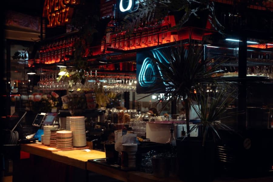 Interior of a Bristol bar at night with atmospheric lighting over the servery