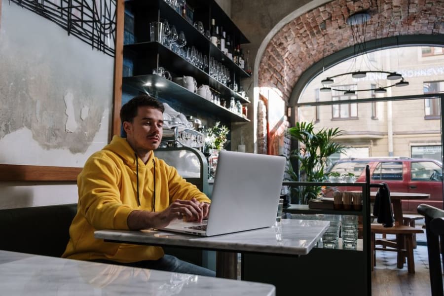 Customer working on a laptop where cafe seating power is useful