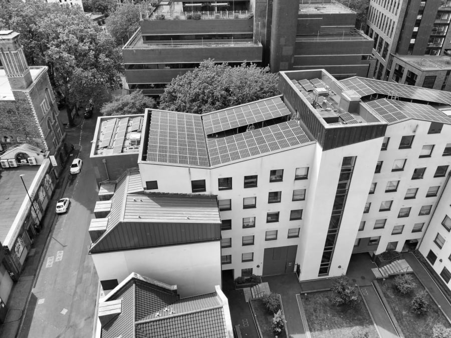 Aerial view of modern buildings with solar panels and a street below