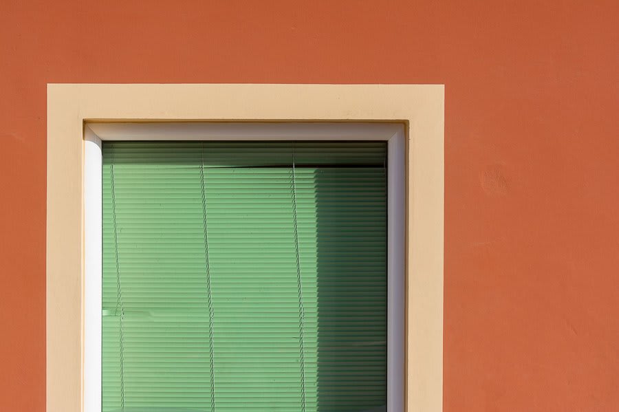 Green window frames on house exterior showing Chartwell green uPVC colour