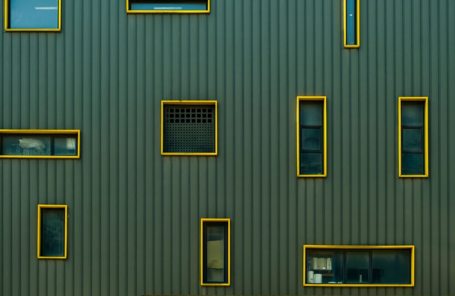 Range of coloured window frames on modern home exterior showing colour options