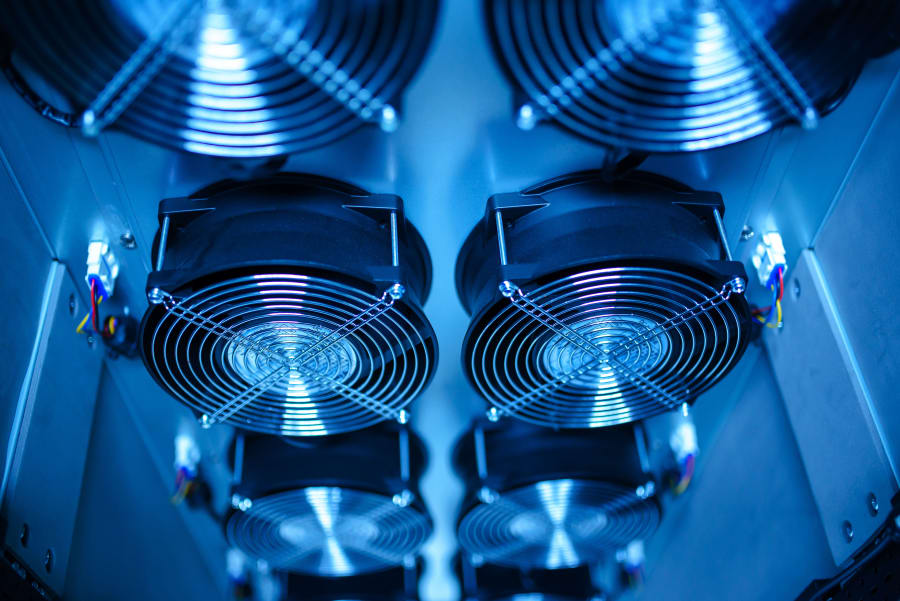 Blue-lit computer hardware with two large cooling fans inside a case