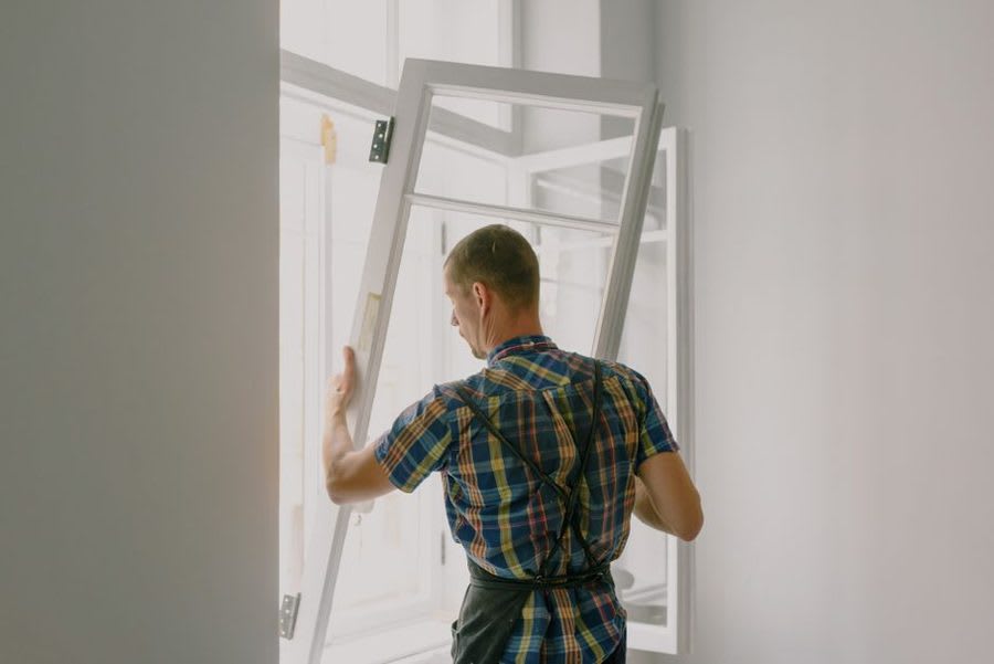 Installer fitting a new door frame in an Exeter property
