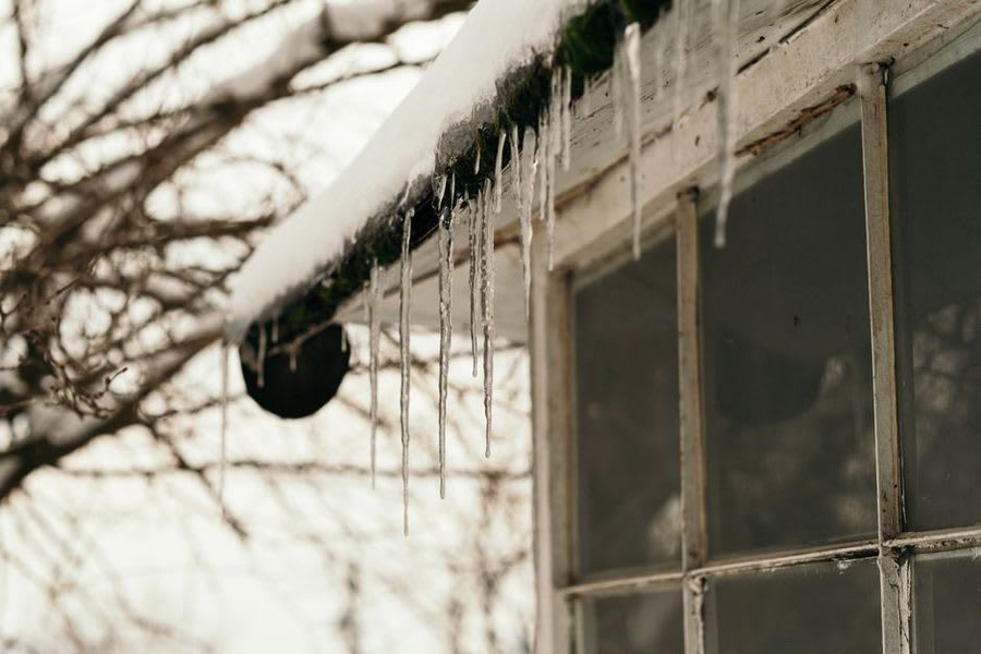 Cold draught coming through a poorly sealed window gap in winter