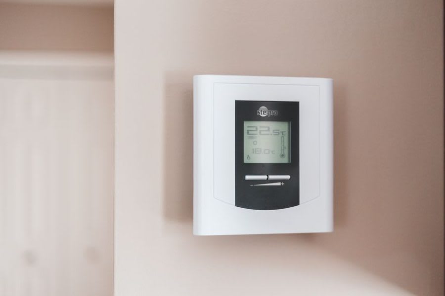 Smart thermostat showing home heating controls after window upgrade