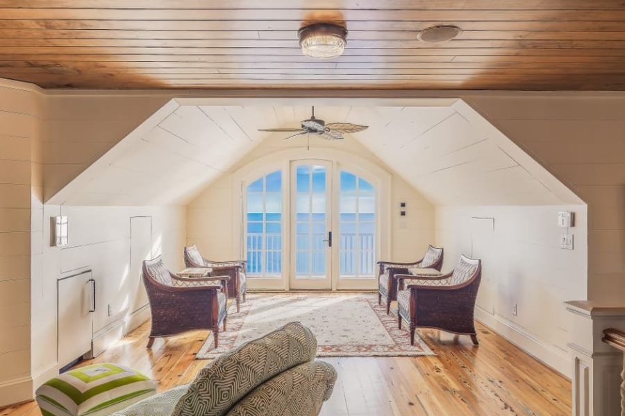 Living space created by a dormer loft conversion, with French doors set into the dormer face