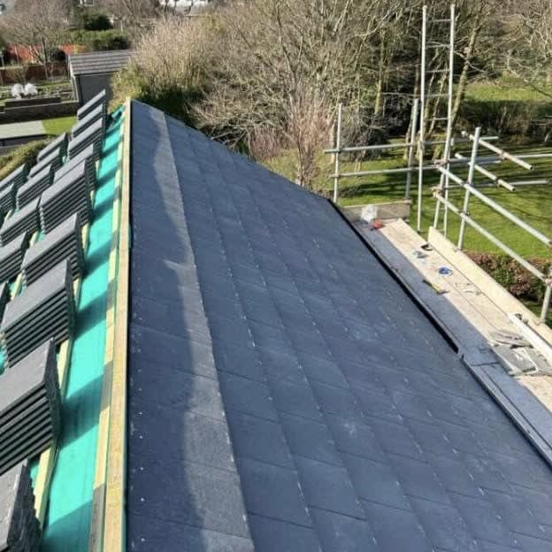 Roof stripped back to the rafters with breather membrane and battens going on during a loft conversion in Cornwall