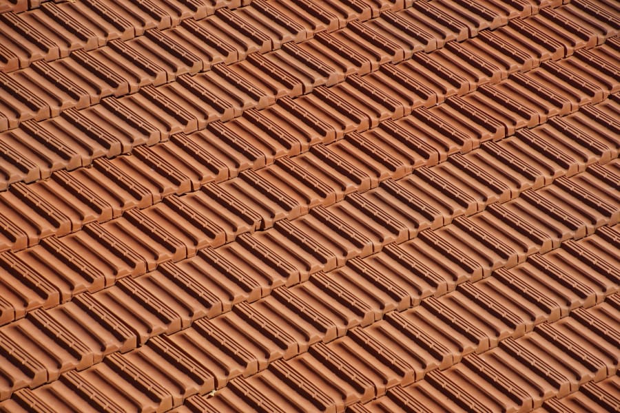 Rows of reddish-brown terracotta roof tiles in a repeating diagonal pattern