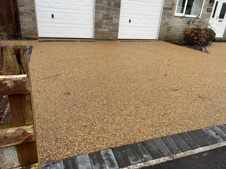 Grey resin driveway with a block paving diamond on it