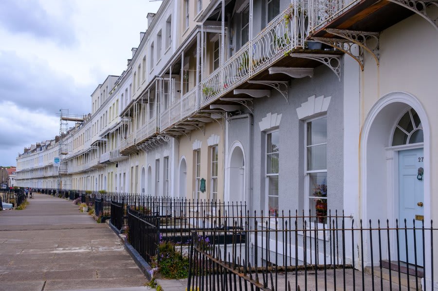 Conservation area terrace in Exeter with listed properties showing consistent window character