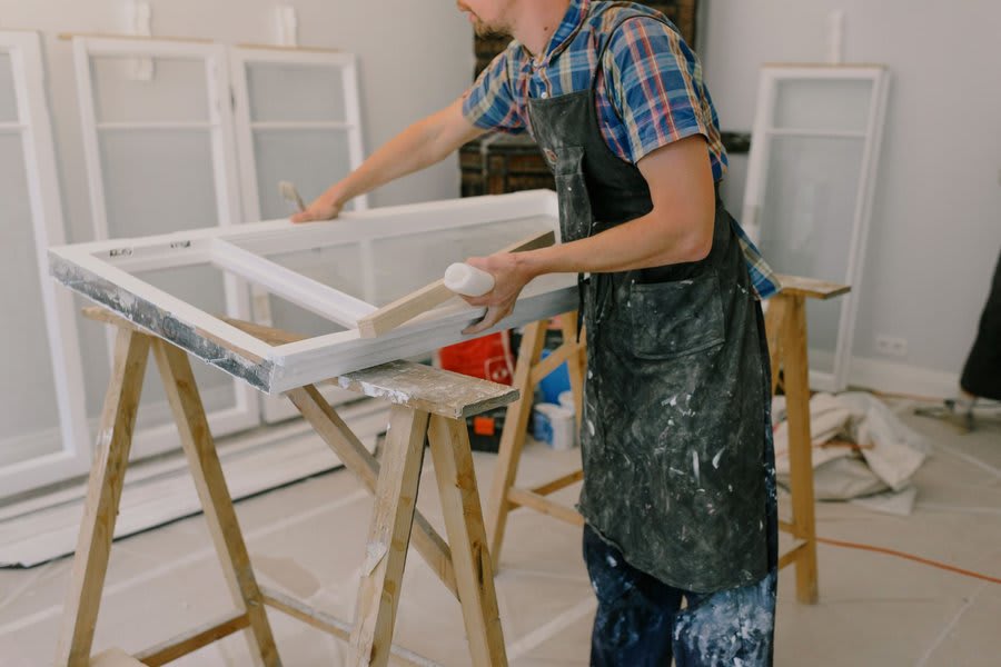 Timber window frame repair work showing restoration of period joinery on listed building