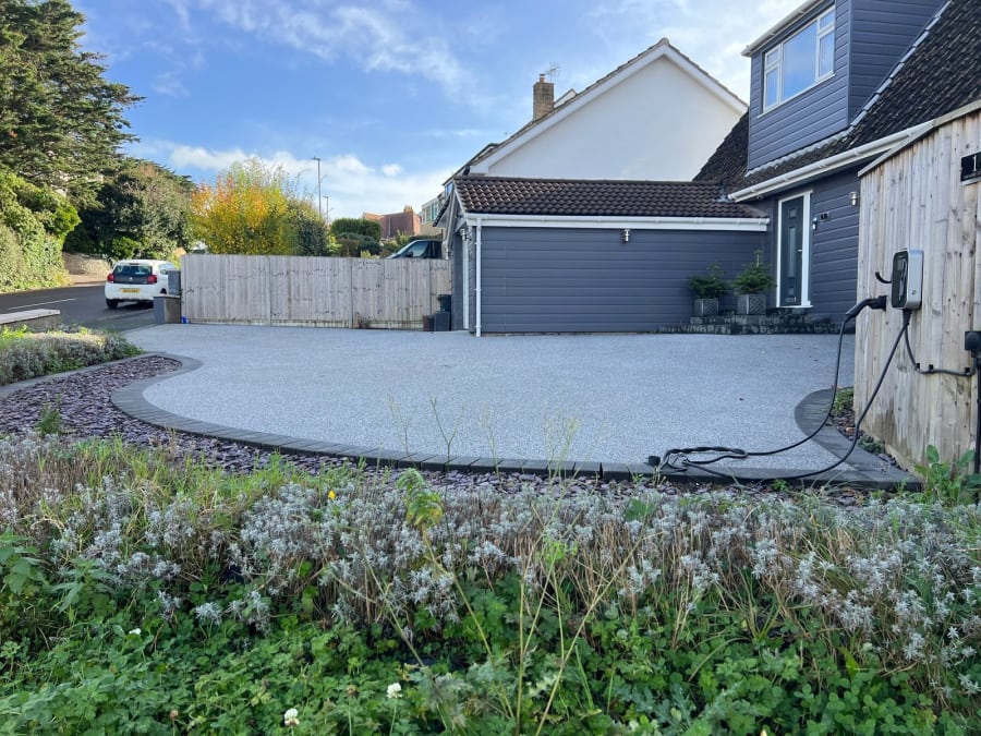 Grey resin driveway with two-tone in white, and block border in grey.