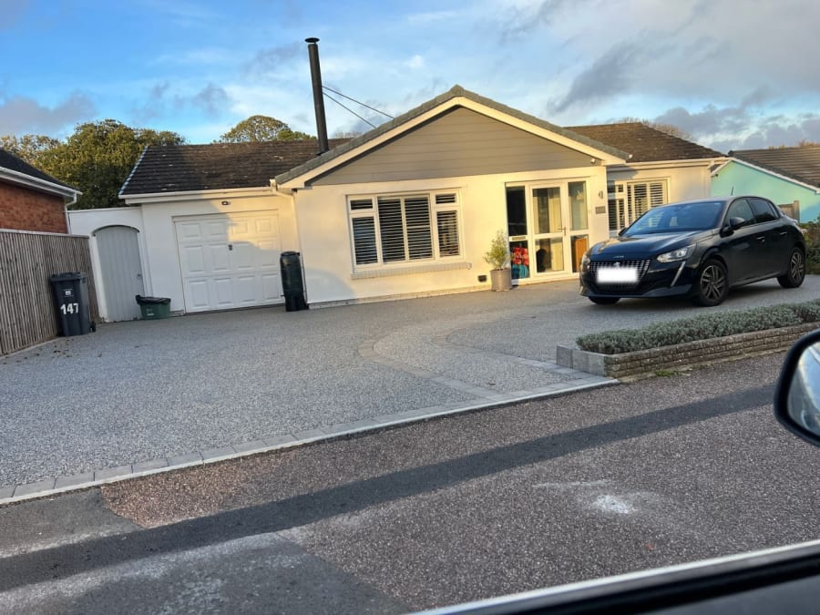Resin driveway installation with a block paving and resin pathway leading to the house.