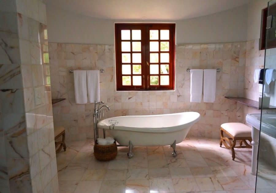 Claw-foot bath in a marble-lined period bathroom