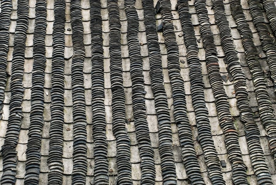 Close detail of an aged slate roof covering in Croydon