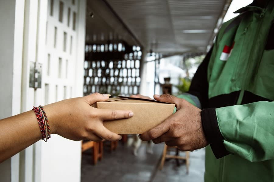 A tradesman meeting a customer at the door of a house in Croydon