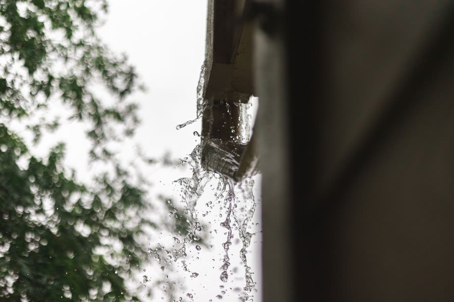 Rainwater running from a roof edge, the kind of symptom that gets blamed on movement