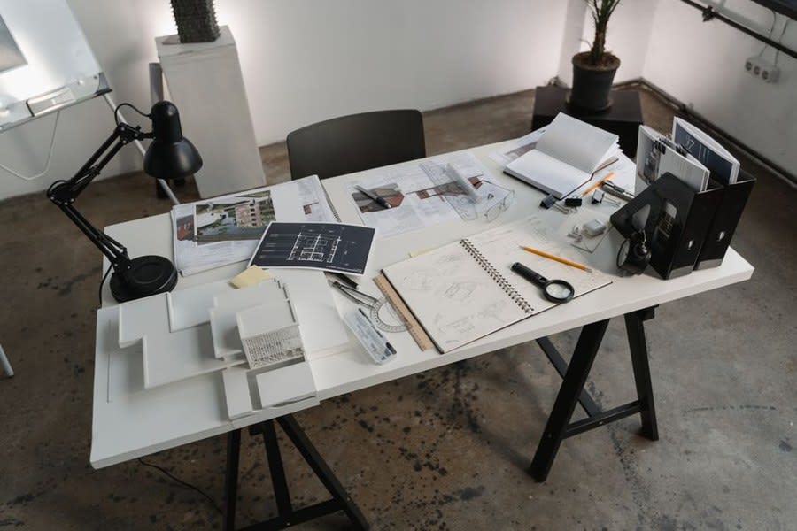 Comparing written flat roofing quotes and specifications on a desk