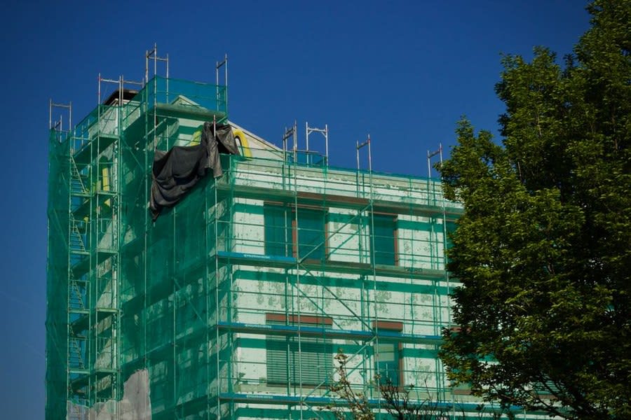 A UK house extension under scaffolding where flat roof building regulations apply