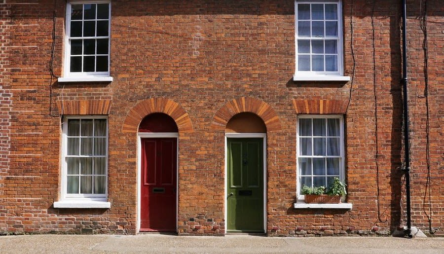 Traditional brick house exterior with multiple windows on several floors
