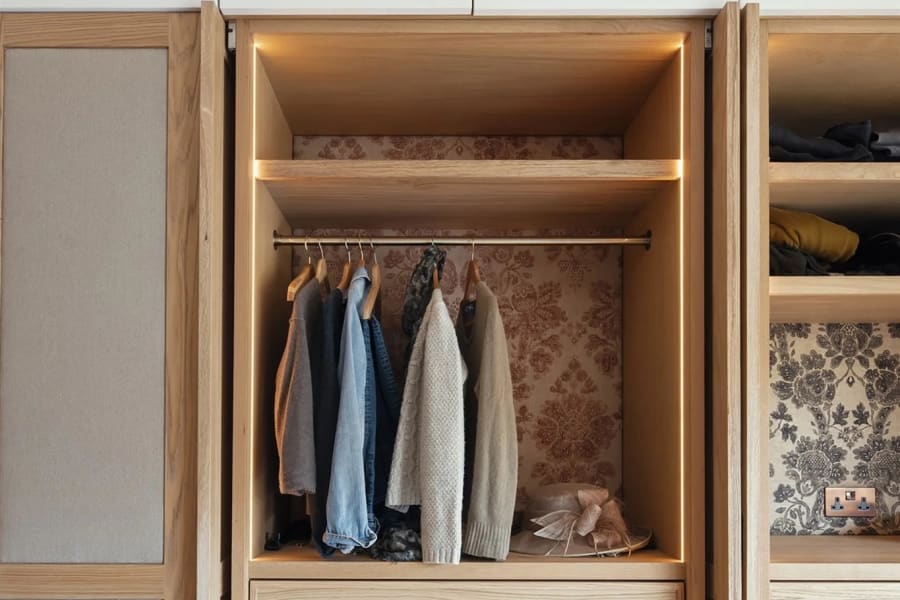 Inside a fitted wardrobe in Torquay showing hanging rails, drawers and shelving