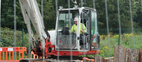 Heffernan Utilities worker operating a digger