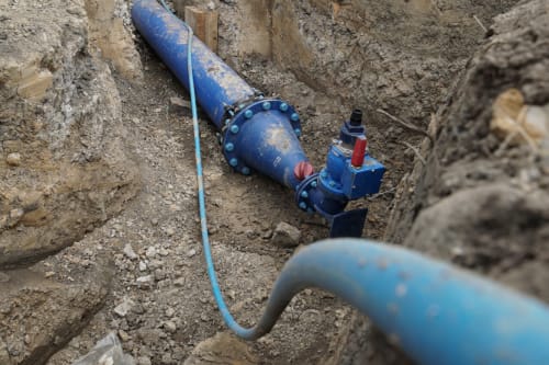 Multi-utility water piping exposed in the ground