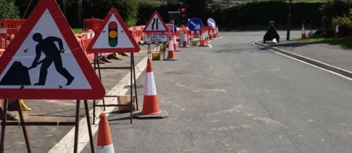 Road side works set up with warning triangles and cones