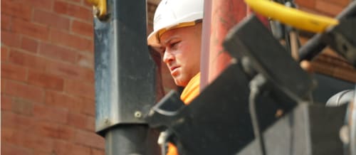 Construction worker operating heavy machinery