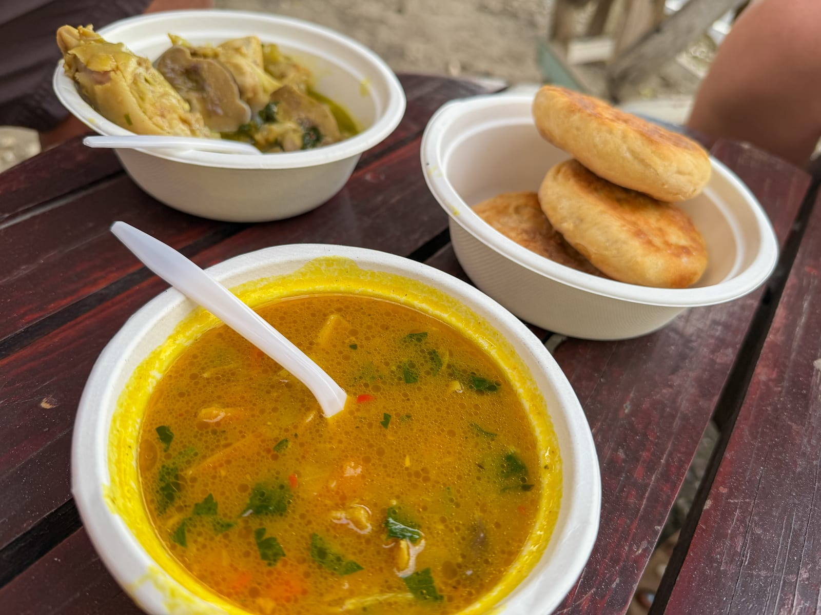 Pumpkin soup, bakes, and oxtail soup from a roadside stand in St. Lucia