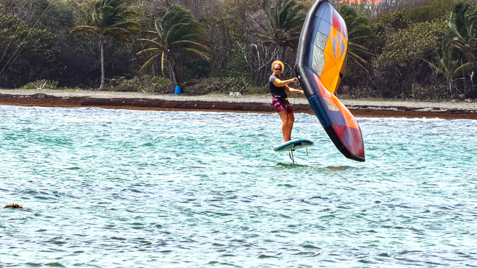 Beth wingfoiling off the north coast of St. Lucia
