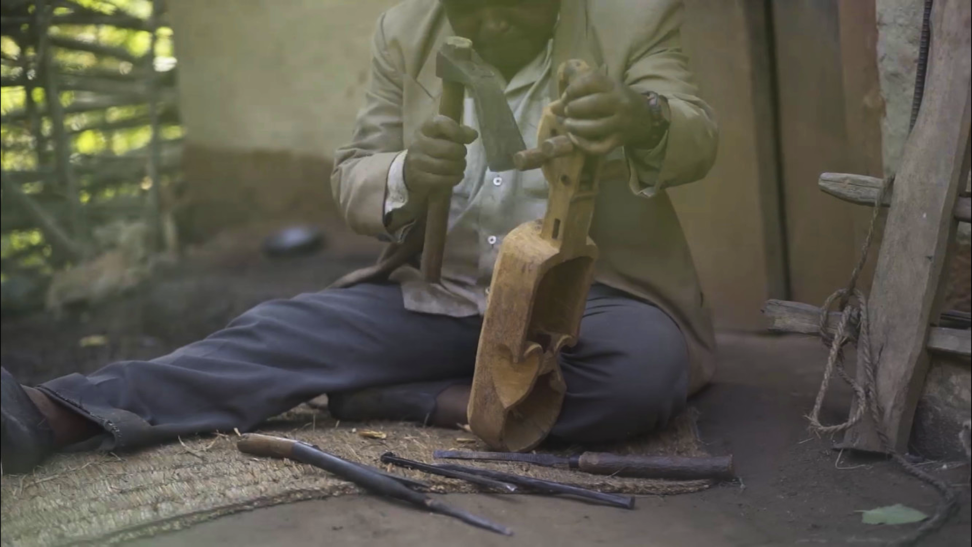 Craftsman carving a sarangi