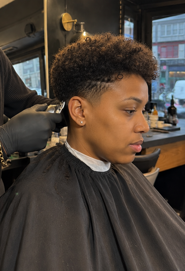 Modern short haircut and bold taper fade on textured hair