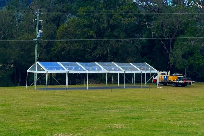 Clear roof marquee wedding reception Brisbane — festoon lighting and dance floor