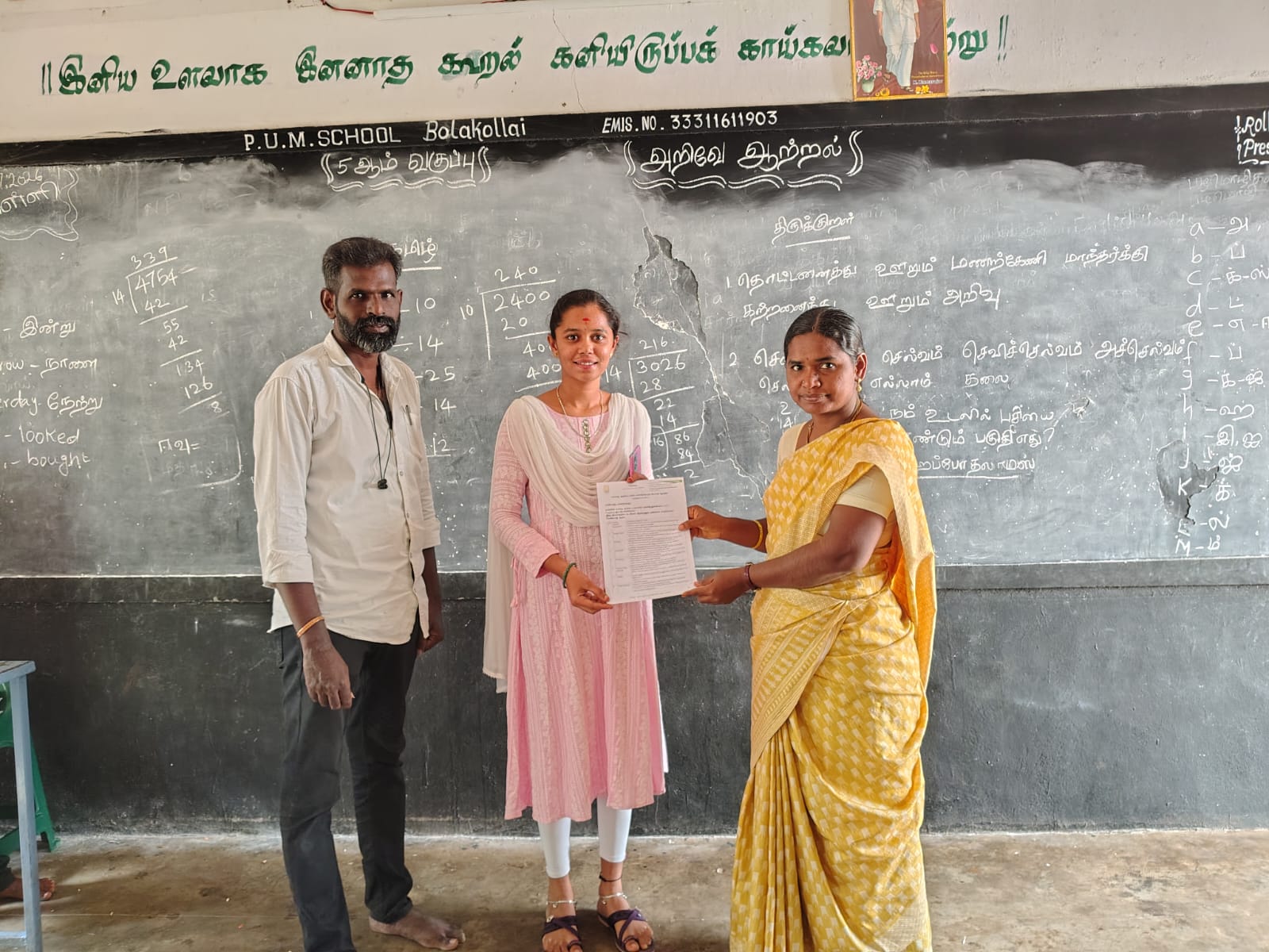 Vazhai field coordinator handing an appointment letter at Bollakollai school