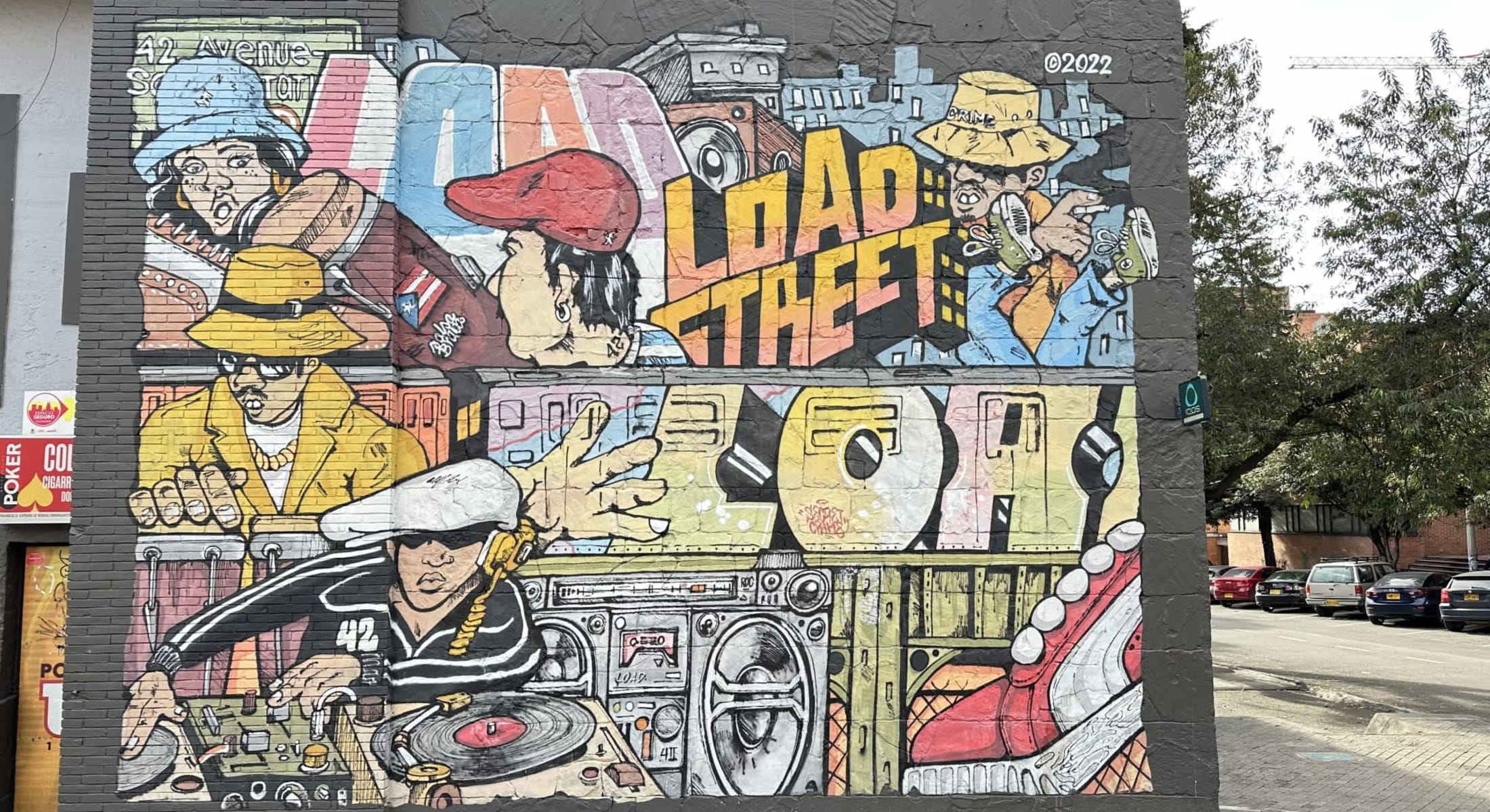 Colorful graffiti mural with characters and urban elements in Bogotá