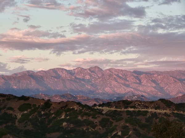 Distant mountain range under a partly clouded sky.