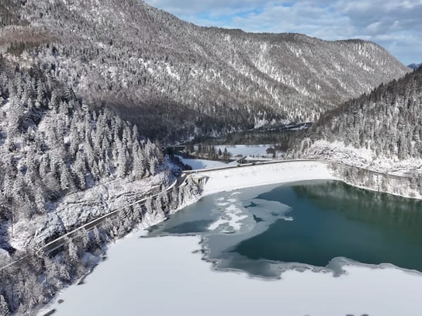 Concrete dam bordering a frozen lake at Lake Sylvenstein, Bavaria.