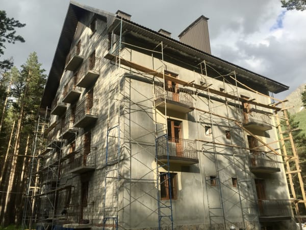 Soviet-era lodge under scaffolding renovation, Mount Elbrus Expedition area