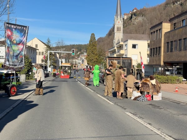 Street parade with costumed participants and tractor float in Vaduz