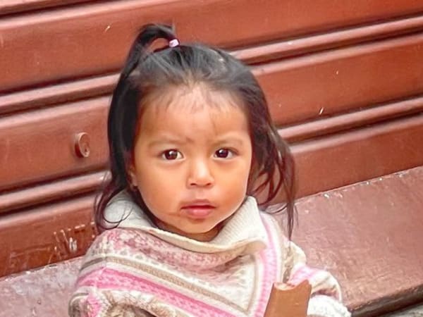 Young local child holding ice cream in Quito, Ecuador