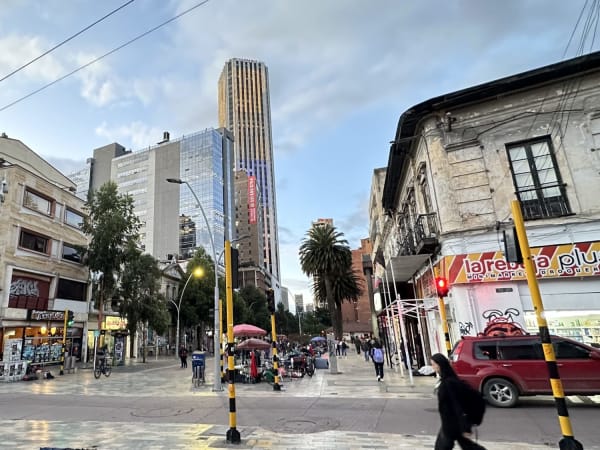Urban street with pedestrians, cars and high-rise buildings in Bogotá Colombia