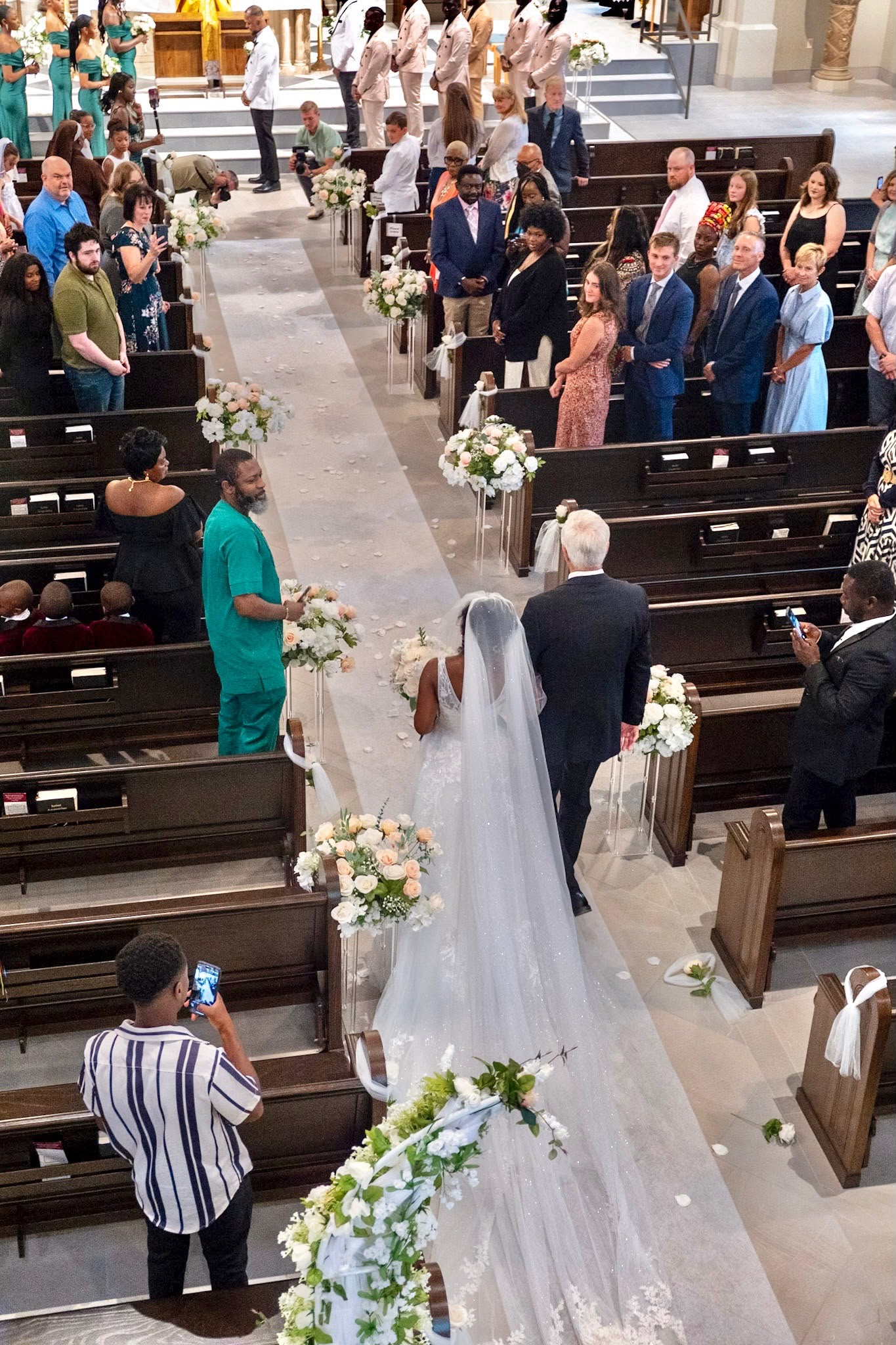 Bride walking down the church aisle during an elegant wedding ceremony planned by Mariveno