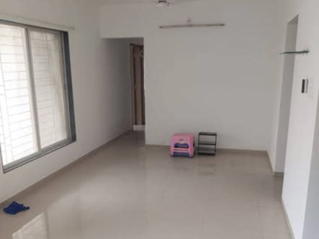 Single-occupancy room in 3BHK at Wakad, Pune — living area and home amenities