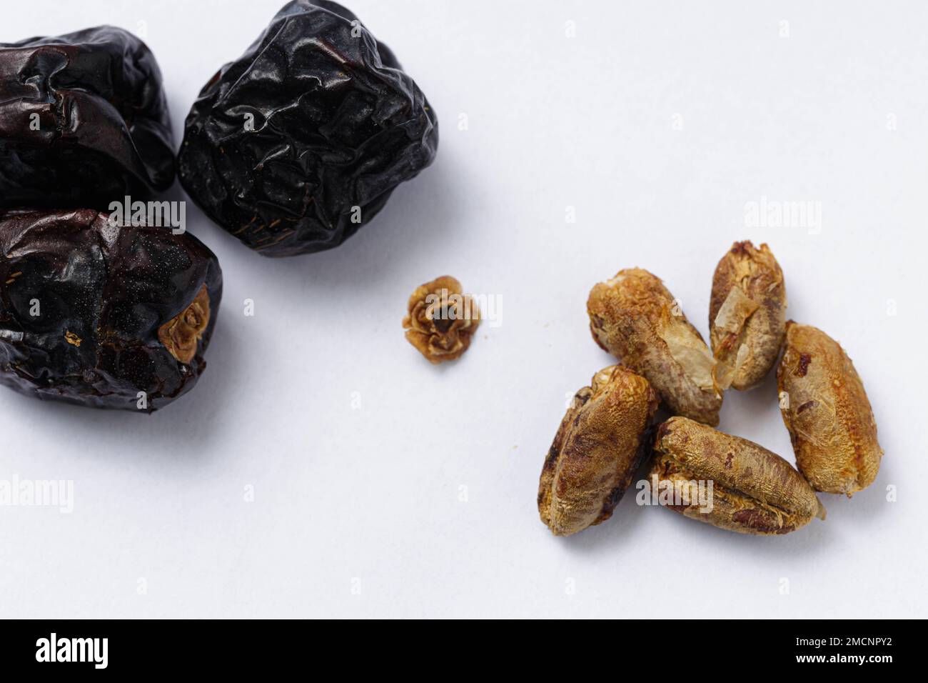 a-macro-shot-of-ajwa-type-dates-with-seeds-on-a-white-background-2MCNPY2.jpg 1