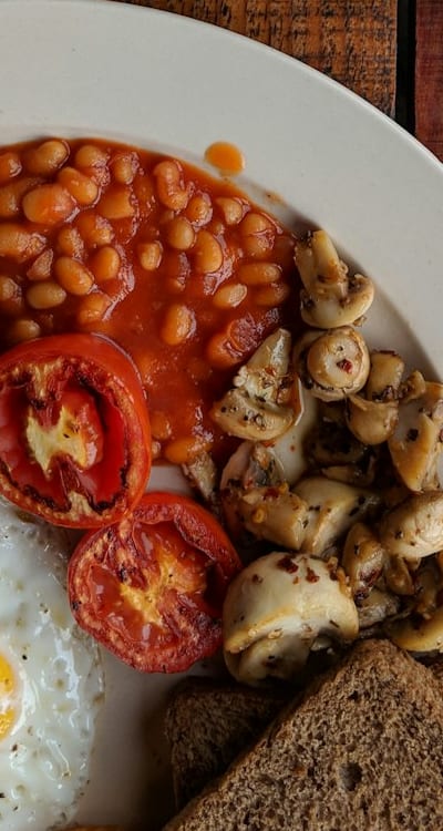 Pole beans growing on a trellis in a garden