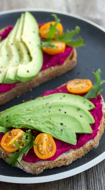 Spaced beet seedlings in a garden bed.