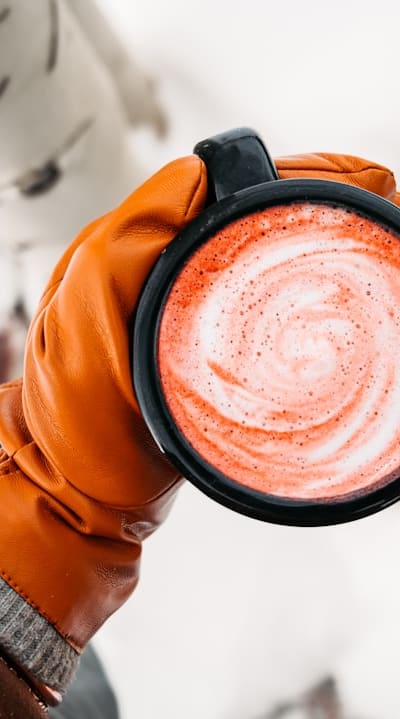 A gardener thinning beet seedlings with a small hoe.